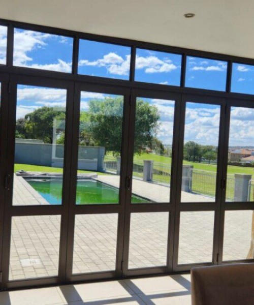 7-Panel-Folding-Door-in-Bronze-with-mid-rail-and-a-fixed-top-light-1