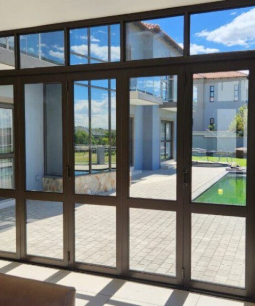 7-Panel-Folding-Door-in-Bronze-with-mid-rail-and-a-fixed-top-light