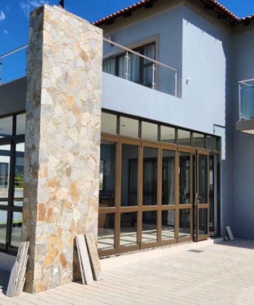 7-and-5-Panel-Folding-Door-in-Bronze-with-mid-rail-and-fixed-top-light