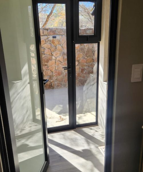 Hinged-single-door-with-white-trans-glass-and-a-hinged-door-with-a-side-light-and-insert-with-a-fly-screen-in-black-1